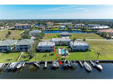 Waterfront property featuring boat dock, boat lift, swimming pool and coastal views at 3233 Wood Thrush Dr # 23C, Punta Gorda, FL 33950