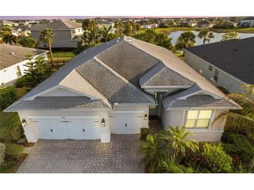 Stunning home featuring a three-car garage, brick paved driveway and lush landscaping in a well-maintained community at 17917 Wayside Bnd, Punta Gorda, FL 33982