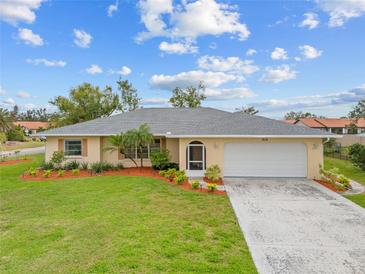 Charming single-story home with a well-manicured lawn and mature landscaping at 916 S Gondola Dr, Venice, FL 34293