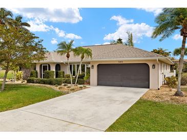 Charming single-story home with a well-manicured lawn and a two-car garage at 1452 Wassail Ln, Punta Gorda, FL 33983