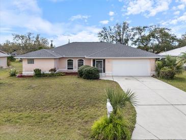 Charming single-story home with well-maintained lawn and a two-car garage at 4461 Baroda Ave, North Port, FL 34287