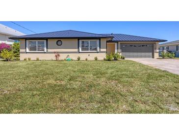 Charming single-story home with a well-manicured lawn and updated roofing at 430 Capri Isles Ct, Punta Gorda, FL 33950