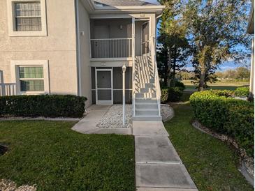 Inviting condo exterior with well-maintained landscaping and a pathway to the entrance at 1340 San Cristobal Ave # 207, Punta Gorda, FL 33983
