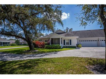 Charming home featuring a lush landscaped front yard with a welcoming two-car garage at 1474 Red Oak Ln, Port Charlotte, FL 33948