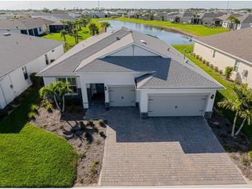 Charming single-Gathering home with a well-manicured lawn and a brick driveway leading to a two-car garage at 15809 Appalachian Dr, Punta Gorda, FL 33982