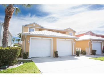 Inviting two-story exterior with a two-car garage, and a lush green lawn adding curb appeal to this charming home at 2002 Bal Harbor Blvd # 311, Punta Gorda, FL 33950