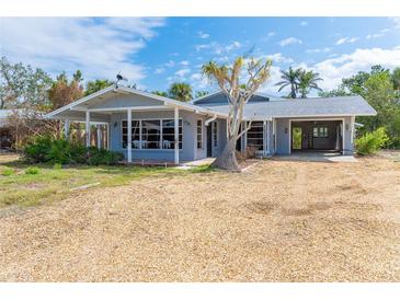 Charming single-story home featuring a well-maintained exterior and ample yard space on a sunny day at 231 Winson Ave, Englewood, FL 34223
