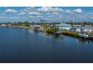 Scenic waterfront home featuring a private boat dock and stunning canal views at 137 Poinsettia Ne Cir, Port Charlotte, FL 33952