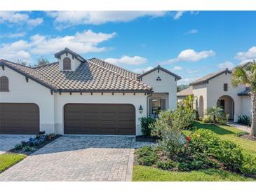 A charming single-story home with a tile roof, well-manicured lawn, and a two-car garage, perfect for a Gathering at 27500 Janzen Ct, Englewood, FL 34223