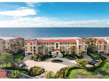 Beautiful exterior shot of a multi-story condominium building with well-manicured landscaping and water views at 87 Vivante Blvd # 8732, Punta Gorda, FL 33950