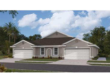 Charming single-story home with gray siding, white trim, two-car garage and manicured lawn at 9459 Sunbeam Cir, Punta Gorda, FL 33950