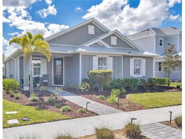 Charming one-story home boasts lush landscaping, well manicured lawn, and a welcoming walkway leading to the front door at 42210 Lake Timber Dr, Punta Gorda, FL 33982