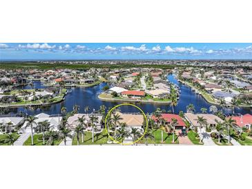 Aerial view of waterfront homes showcasing backyard canals and landscaping in tropical community at 494 Monaco Dr, Punta Gorda, FL 33950