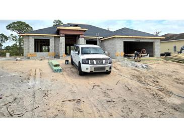 New construction featuring a modern design, concrete block construction, and a dark shingle roof at 5154 Gibson Ln, Port Charlotte, FL 33981