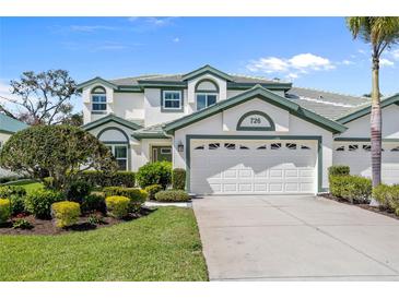 Charming two-story home featuring a well-maintained lawn and a spacious two-car garage at 726 Connemara Ct, Venice, FL 34292