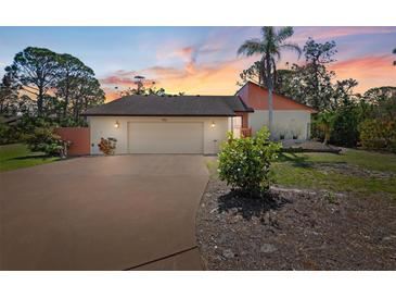 Charming single-Gathering home featuring an attached two car garage and lush landscaping at 1701 Overbrook Rd, Englewood, FL 34223