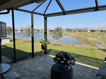 Enjoy serene water views from this screened-in patio with brick pavers and comfortable seating at 7304 W Lenox Circle, Punta Gorda, FL 33950