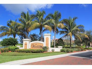 Inviting community entrance with palm trees and attractive landscaping at 99 Vivante Blvd # 404, Punta Gorda, FL 33950