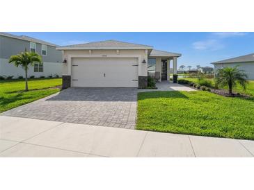 Charming single-story home featuring a two-car garage and a well-manicured front yard with stone driveway at 17954 Saddle Rd, Punta Gorda, FL 33982