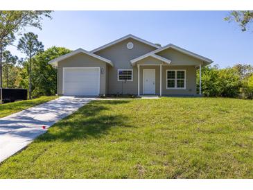 Charming one-story home with a well-manicured front yard and a one car garage at 11401 2Nd Ave, Punta Gorda, FL 33955