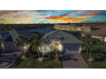 Beautiful single-Gathering home with lush landscaping and a gorgeous lake view at sunset at 13056 N Marsh Dr, Port Charlotte, FL 33953