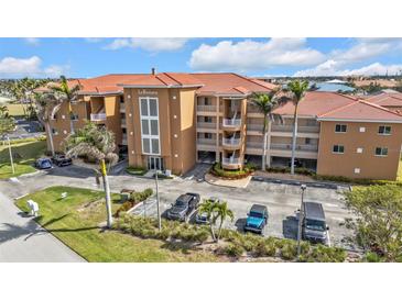 Condominium building with a tile roof and multiple levels with parking at 3322 Purple Martin Dr # 127, Punta Gorda, FL 33950