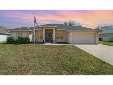 Charming single Gathering home with a well-manicured lawn and attached two car garage at 312 Mendoza St, Punta Gorda, FL 33983