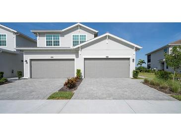 Charming two-story home with two-car garage and well-maintained driveway and manicured landscaping at 15951 Grassland Ln # 3812, Punta Gorda, FL 33982