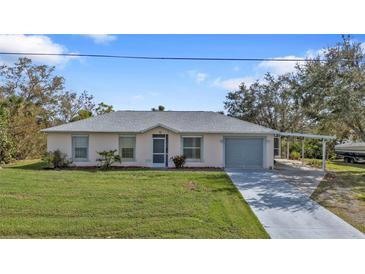 Charming single-story home with a well-maintained lawn and attached carport at 3436 Discovery Dr, Punta Gorda, FL 33983