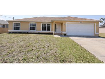 Inviting single-story home featuring a well-maintained lawn, attached garage, and neutral color palette at 4237 Irdell Ter, North Port, FL 34288