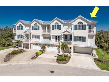 Beautiful multi-level townhouses with light exteriors, multiple balconies, and garages at 10300 Tarpon Landings Ter # 4, Placida, FL 33946