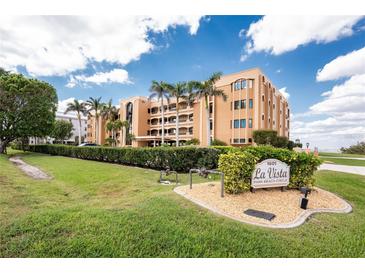 Beautiful condo building with well-manicured landscaping and mature trees creates an inviting and luxurious entrance at 1601 Park Beach Cir # 114/4, Punta Gorda, FL 33950