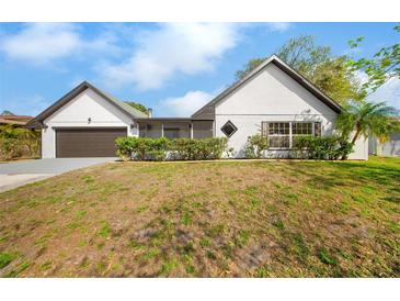 Charming single-story home with a well-maintained lawn and an attached garage at 2027 59Th N St, Clearwater, FL 33760