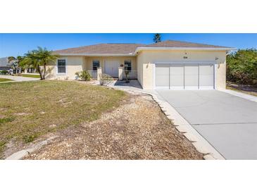 Charming single-story home with a well-manicured lawn, attached garage, and a welcoming facade at 7014 Baylor Street, Englewood, FL 34224