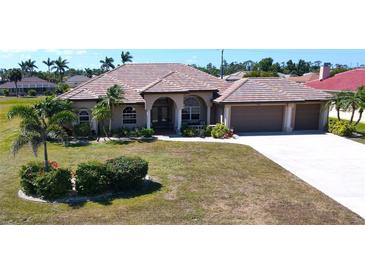 Beautiful single-story home featuring a tile roof, a spacious front lawn, and a two-car garage at 569 Royal Poinciana, Punta Gorda, FL 33955