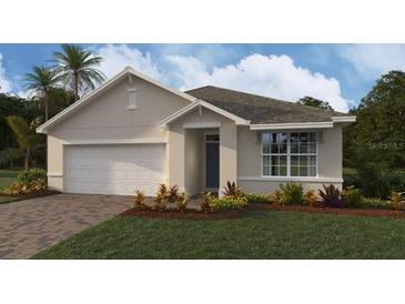 Charming single-story home featuring a neutral color scheme, attached two-car garage, and well-maintained front yard at 9584 Turtle Grass Cir, Punta Gorda, FL 33950