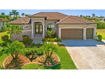 Charming single-story home with a well-manicured lawn and a two-car garage at 1341 Pine Siskin Dr, Punta Gorda, FL 33950