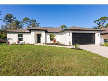 Charming single-story home with a well-manicured lawn and modern black trim at 18124 Goliad Ave, Port Charlotte, FL 33954