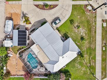 Expansive waterfront property featuring a pool, boat dock, and lush landscaping, providing a serene coastal living experience at 21194 Edgewater Dr, Port Charlotte, FL 33952