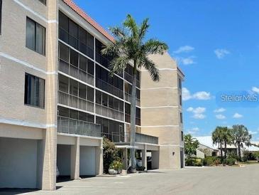 Beautiful building with a well-manicured lawn and mature landscaping at 25188 Marion Ave # F106, Punta Gorda, FL 33950