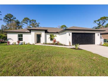 Charming single-story home featuring a well-maintained lawn and attached two-car garage at 2683 Denicke St, North Port, FL 34286