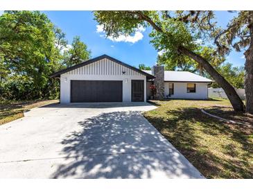 Charming single-story home featuring an attached two-car garage and a concrete driveway at 16249 Ashland Ave, Port Charlotte, FL 33954