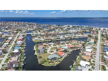 Stunning aerial view of waterfront homes with canals, docks, and ocean access, showcasing coastal living at 1791 Belle Ct, Punta Gorda, FL 33950