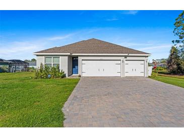 Charming single-story home featuring a spacious three-car garage and well-manicured lawn at 25336 Deep Creek Blvd, Punta Gorda, FL 33983