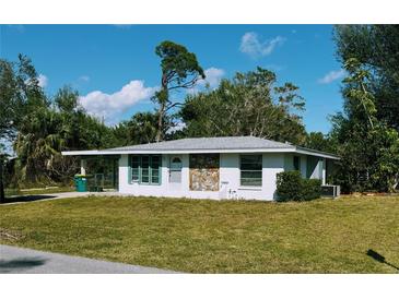 Charming single-story home with well-maintained lawn and decorative stone accents at 3308 Pinetree St, Port Charlotte, FL 33952