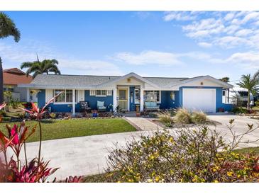 Inviting single-story home boasting a colorful exterior, a well-manicured lawn, and cozy front porch at 4279 Harbor Blvd, Port Charlotte, FL 33952