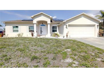 Charming single-story home with solar panels, two-car garage, and well-kept lawn at 7882 Dulce Ave, North Port, FL 34287