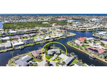 Beautiful aerial view of a waterfront home with private dock and direct access to the open water at 955 Don Juan Ct, Punta Gorda, FL 33950