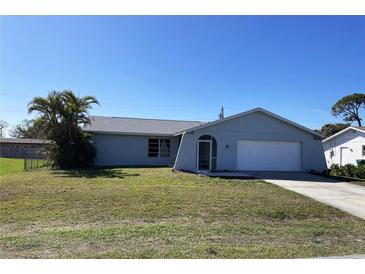 Charming single-story home featuring a well-maintained lawn and a welcoming, arched entryway at 234 Shadow Nw St, Port Charlotte, FL 33952