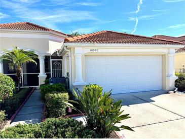 Inviting single-story home with a well-maintained lawn, mature landscaping and a terracotta roof at 10900 Lerwick Cir, Englewood, FL 34223